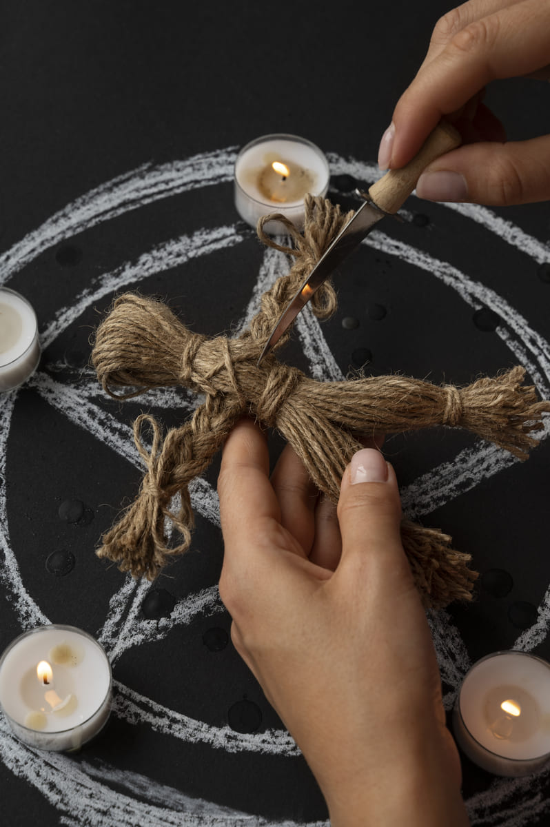 hands-stabbing-voodoo-doll-high-angle